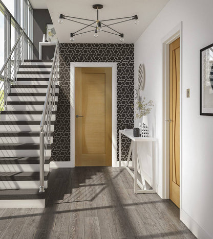 Modern interior with staircase, geometric-patterned wall, and wooden doors.