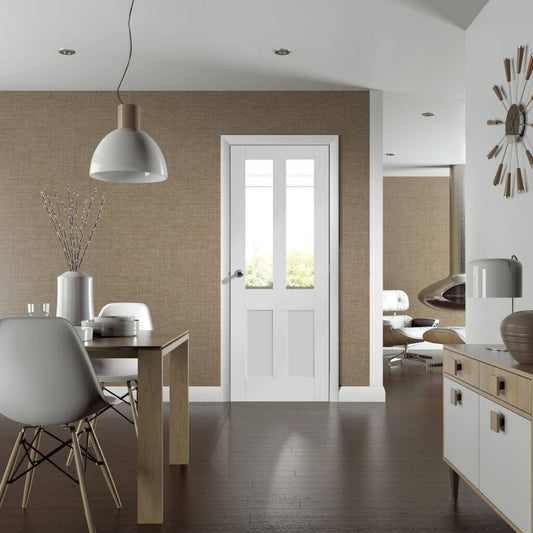 Modern interior with a dining table, chairs, and a white door.