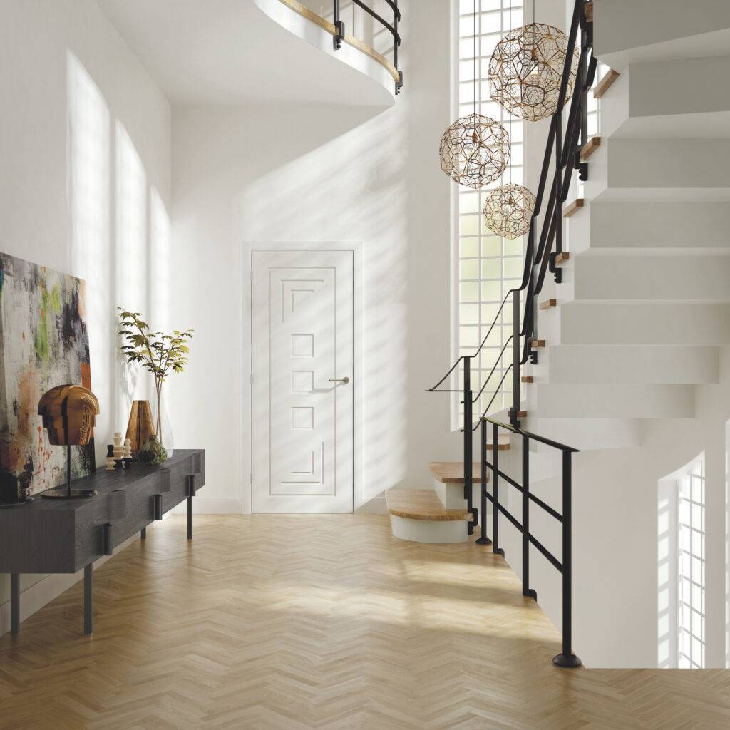 Modern interior with a staircase, white walls, and decorative elements.