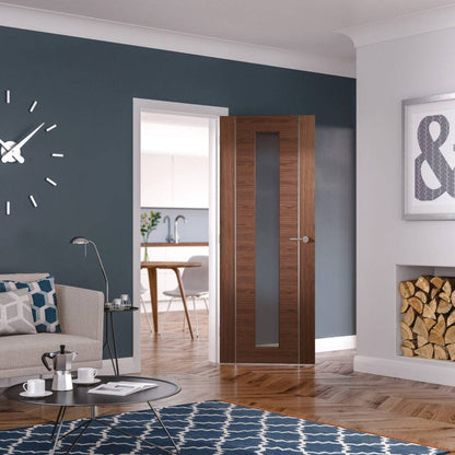 Modern living room with a wooden door, sofa, and coffee table.